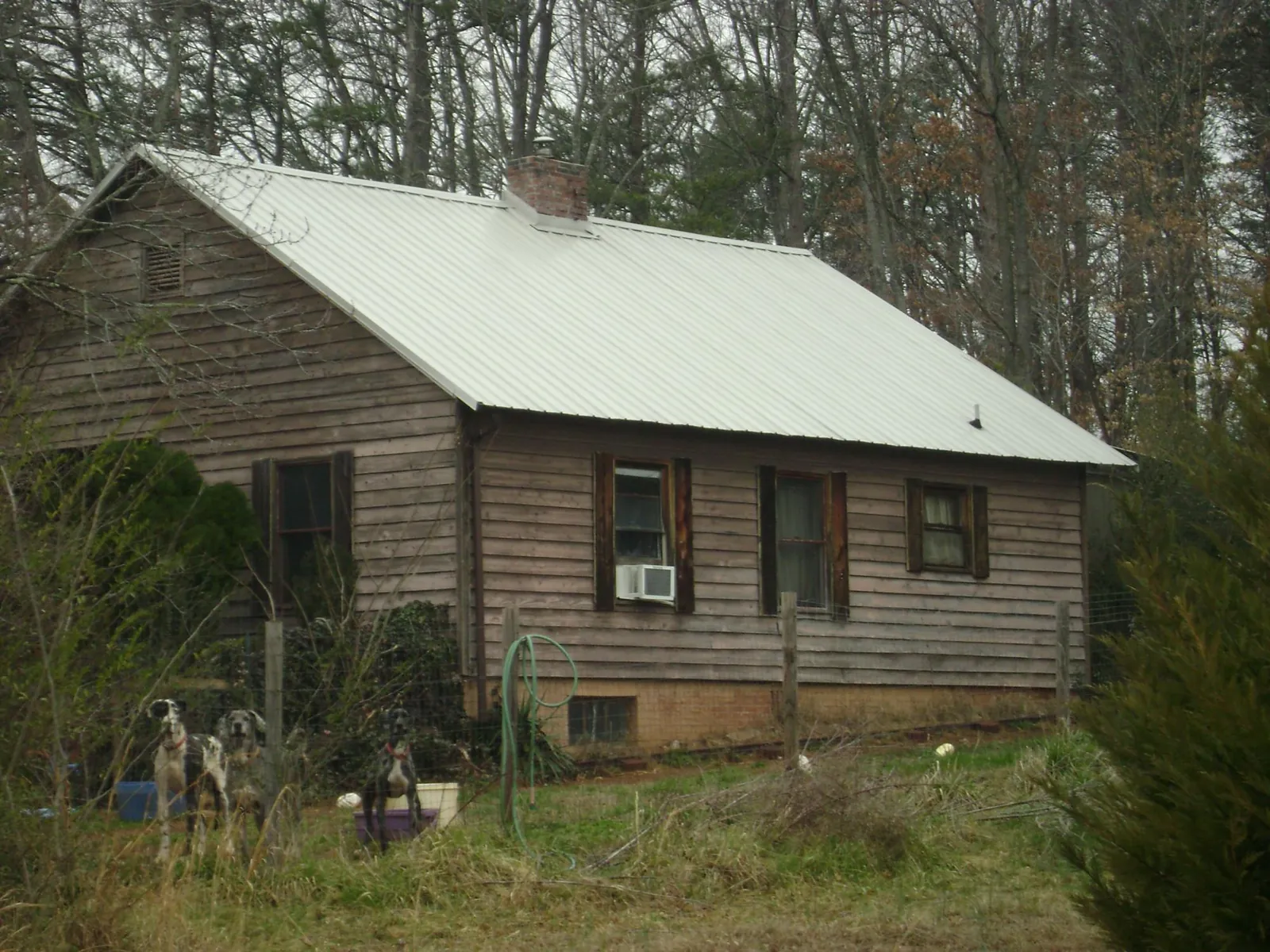 White metal roof on an old wood sided farmhouse, from a Metal Roof Installation job in Haydenville